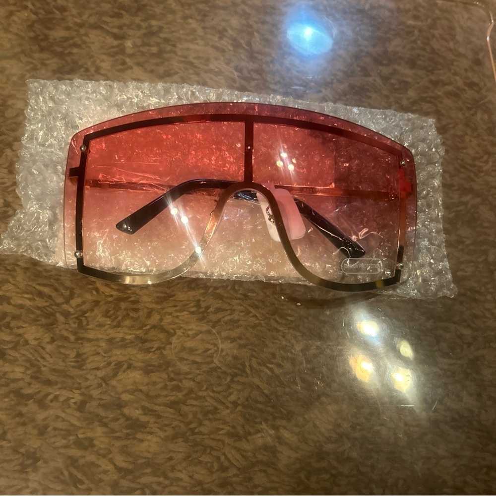 Brand new pink squared sunglasses with a gold rim.